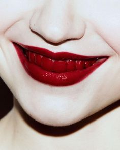 a close up shot of a woman's face with red lipstick