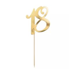 a gold cake topper with the number eight on it