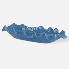 a blue ceramic bowl with waves on it