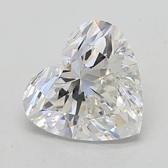 a heart shaped diamond on a white surface