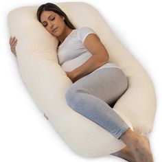 a pregnant woman laying on an inflatable pillow with her stomach tucked under it