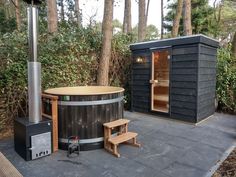 a hot tub sitting next to a wooden bench