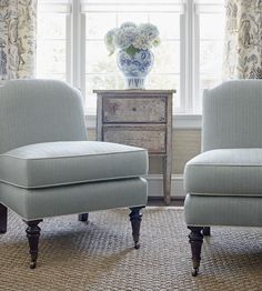 two blue chairs in front of a window