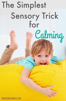 a young boy laying on top of a bean bag chair with the text, the simplest sensory trick for calming