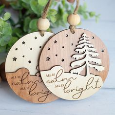 two wooden christmas ornament hanging from strings