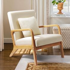 a white chair sitting in front of a window