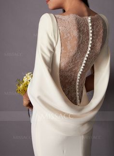 the back of a woman wearing a white dress