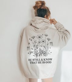 Embrace the comforting message of "Be Still and Know that I am God" with this stylish hoodie, perfect for women seeking trendy Christian apparel that incorporates Bible verses. Stay cozy and fashionable in this oversized sweater designed to reflect a modern aesthetic while spreading a meaningful religious message. ABOUT THE HOODIE Gildan 18500 50% cotton, 50% polyester Medium-heavy fabric  Classic fit Tear-away label Runs true to size Size UP 1-2 Sizes for oversized fit SHIPPING AND PROCESSING A Oversized Comfortable Hoodie With Letter Print, Oversized Hoodie With Letter Print, Comfortable, Inspirational Letter Print Hoodie For Fall, Inspirational Hoodie Sweatshirt For Fall, Inspirational Graphic Print Hoodie For Fall, Inspirational Fall Hoodie Sweatshirt, Inspirational Cotton Crew Neck Hoodie, Inspirational Oversized Sweatshirt With Letter Print, Oversized Inspirational Letter Print Sweatshirt