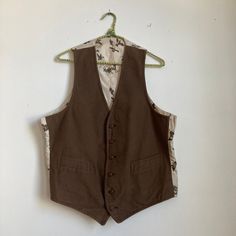 Neat moleskin vest, not sure of age. 1940s in style but possibly made later.  Great condition. Underarm to Underarm: 22" Length: 24.5" Please ask any questions before purchasing, especially concerning fit or condition. All items are vintage and in condition as described. Shipping via USPS unless otherwise agreed upon. All sales final, no returns- Thank You from Collecting Dust! Retro Brown Cotton Vest, Vintage Workwear Vest With Pockets, Vintage Vest With Pockets For Work, Retro Brown Vest For Workwear, Retro Brown Vest For Work, Retro Sleeveless Vest For Work, Classic Brown Cotton Vest, Vintage Vest With Pockets, Vintage Brown Cotton Vest