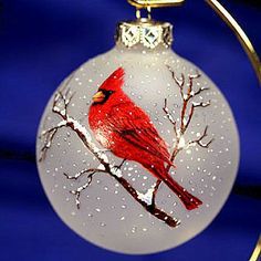 a glass ornament with a cardinal on it