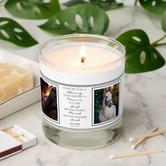 a candle sits on a marble table next to some matches and a box of matches