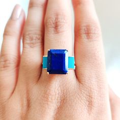 This stunning ring is set in 14k Solid Yellow Gold with Natural Lapis Lazuli and Arizona Turquoise with utmost precision. It is an unique statement gemstone ring for nearly every occasion and is completely hassle-free jewelry. ITEM DETAILS * Center Gem: Lapis Lazuli * Gem Size: 10X12mm * Gem Shape: Octagon cut * Gem Weight: 6.36 carats * Side Gem: Turquoise * Gem Size: 3X6mm * Gem Shape: Baguette cut * Gem Weight: 0.39 carats * Gem Weight: 7.01 carats * Gold Purity: 14KT * Gold Weight: 2.17 gram Emerald Cut Turquoise Gemstone Jewelry, Turquoise Emerald Cut Gemstone Jewelry, Blue Turquoise Ring In 14k Gold, Blue Turquoise 14k Gold Fine Jewelry Ring, Formal 14k Gold Turquoise Blue Ring, Turquoise Gemstone Rings With Emerald Cut, Emerald Cut Turquoise Gemstone Ring, Turquoise Emerald Cut Gemstone Ring, Turquoise Emerald-cut Gemstone Ring