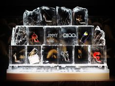 an assortment of shoes and purses are displayed in ice cubes with the word jimmy written on them