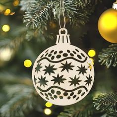 a white ornament hanging from a christmas tree