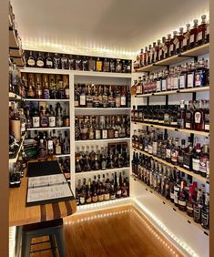 a room filled with lots of bottles and shelves full of different types of liquors