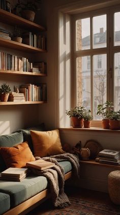 a living room filled with lots of furniture and bookshelves next to a window