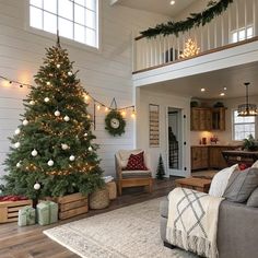 a living room filled with furniture and a christmas tree in the middle of the room