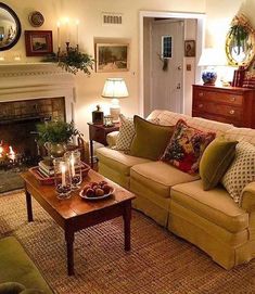 a living room filled with furniture and a fire place in front of a mirror on the wall