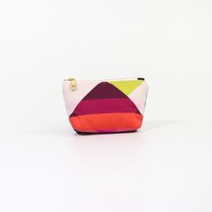 Introducing the Geometric Poofy Coin Pouch: a delightful blend of charm and versatility. This unique pouch combines a playful pink geometric pattern on one side with durable navy dry oilskin on the other, offering a stylish contrast that stands out. Measuring approximately 3.5" x 5" with a poofy, 1" gusseted design, this pouch not only holds your coins and small essentials but also stands on its own for easy access. The brass-colored metal zipper ensures secure closure, while adding a touch of vintage elegance to its modern design. Whether slipped into a purse or carried solo, the Geometric Poofy Coin Pouch is perfect for adding a pop of color and personality to your everyday carry. It's an ideal accessory for those who appreciate practicality without compromising on style. Multicolor Zipper Coin Purse, Multicolor Zipper Coin Purse For Everyday, Modern Bags With Card Slots As Gift, Modern Bags With Card Slots For Gift, Modern Bag With Card Slots As Gift, Modern Gift Bag With Card Slots, Modern Portable Pouch For Personal Use, Multicolor Compact Everyday Bag, Modern Coin Purse Pouch For Daily Use