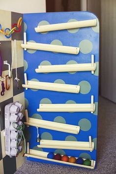 a blue and white board with toothbrushes hanging on it's side next to other items