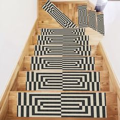 the stairs are decorated with black and white rugs