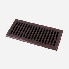 the floor register is brown and has black grates on it, along with a white background