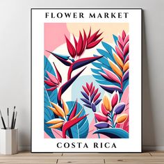 a poster with flowers and plants on it in front of a white vase filled with pencils