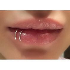 a woman's lips with a nose ring on top of her lip and the bottom part of her mouth