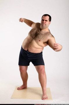 a man standing on top of a mat holding a frisbee in his right hand