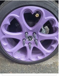 a purple car wheel with hearts on it