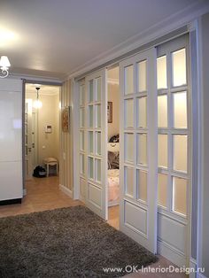 an open door leading to another room with a rug on the floor in front of it