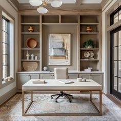 a home office with built - in shelving and desk