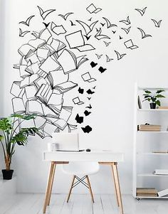 a white desk and chair in front of a wall with black birds flying over it