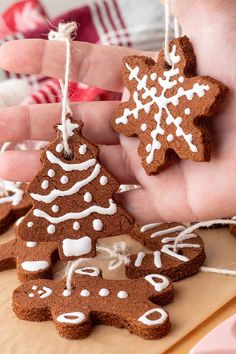 someone is holding two gingerbread cookies in their hand and one has a snowflake on it