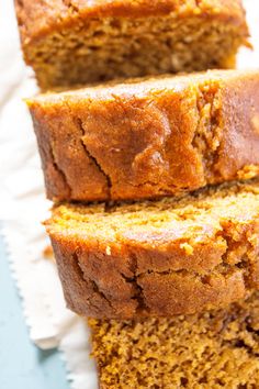 slices of pumpkin bread stacked on top of each other in front of the rest of the loaf