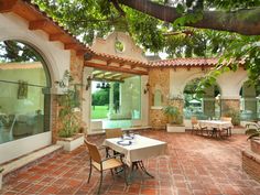 an outdoor dining area with tables and chairs