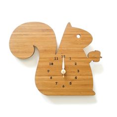 a wooden clock with a squirrel design on it's face and numbers in the middle