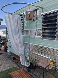 an rv parked on the side of the road with curtains pulled up to it's sides