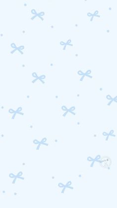 a blue and white wallpaper with bows on it