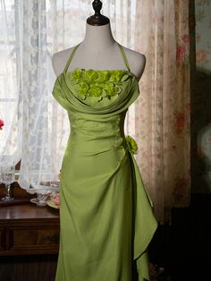 Step into a world of enchantment with this Vintage Green Halter Neck Floral Prom Gown. Designed to capture the essence of fairy-tale elegance, this gown features a lush green hue that evokes the tranquility of nature. The halter neck design beautifully accentuates your shoulders and neckline, offering a graceful and sophisticated look.  Adorned with exquisite floral decorations at the bodice, the dress brings a touch of romance and whimsy. The intricate flower embellishments add a layer of textu Fairy Like Dresses, Pastel Green Prom Dress, Floral Fairy, Prom Inspo, Vintage Party Dresses, Flower Embellishments, Floral Decorations, Magical Fairy, Dream Outfits