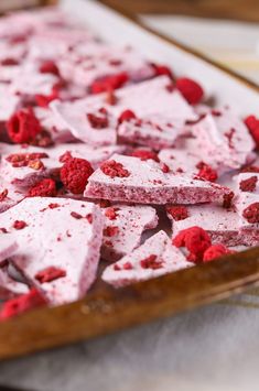 raspberry shortbreads are arranged on a cutting board and ready to be eaten