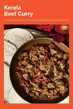 the cover of kerala beef curry is shown on a plate with flowers in the background