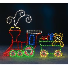 a lit up train with teddy bears on it