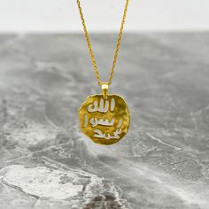 Crafted with exquisite detail and profound symbolism, the Seal of Prophet Muhammad Necklace is a timeless piece of Islamic jewelry that holds deep significance. Made from 925 sterling silver elegantly plated with 18K gold, this necklace radiates elegance and beauty. The intricate design featuring Arabic calligraphy of the Seal of Prophet Muhammad brings a touch of spirituality and tradition. Perfect for a birthday gift, anniversary present, or simply to show appreciation to a loved one, this necklace is a meaningful gesture. Whether for a Muslim friend, a family member, or as a treat for yourself, this necklace encapsulates a blend of faith and fashion. Embodying the essence of Islamic culture, this piece resonates with love, respect, and the teachings of the Quran, making it an ideal gift Spiritual Sterling Silver Coin Necklace Tarnish Resistant, Symbolic Gold Hammered Necklace, Silver Engraved Gold Plated Jewelry, Symbolic Hammered Sterling Silver Necklace, Spiritual Tarnish-resistant Coin Necklace Gift, Spiritual Gold Plated Engraved Coin Necklace, Spiritual Gold-plated Engraved Coin Necklace, Hammered Amulet Coin Necklace As Gift, Hammered Amulet Style Coin Necklace Gift