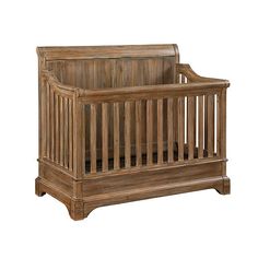 a wooden baby crib sitting on top of a white floor