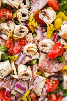 a salad with meat, tomatoes, onions and peppers