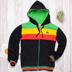 "Thick, fleshy Rasta zip hoodie, made in a fleece-back fabrics. Tightly woven fabric, lightweight design: Cotton 90%, polyester 10%. It features a unisex straight, comfortable regular fit and zip. This hoodie has a double-lined hood and metal grommets. Lion of Judah print on the chest. Logo patch at the bottom: Roots & Culture. Small side insert in Rasta colors. Color: Black & Rasta. Product made in Poland. High quality product, made of the cotton yarn holding certificates: Oeko Tex Standard 100 Green Fleece-lined Sweatshirt For Streetwear, Fleece Track Jacket With Double-lined Hood For Streetwear, Cotton Hoodie With Ykk Zipper, Cotton Fleece Jacket For Streetwear, Urban Fleece Track Jacket With Double-lined Hood, Cotton Fleece Jacket With Fleece Lining For Streetwear, Long Sleeve Cotton Hoodie With Ykk Zipper, Fleece Hoodie With Ykk Zipper, Hooded Fleece Track Jacket With Fleece Lining