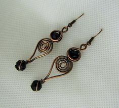 This listing is for one pair wire wrapped Jet Black Crystal in Copper Earrings. Please read all listings carefully and if you have questions, address them to me and I will answer quickly. I thank you for shopping with Sparrow Song. New Pendant by Sparrow Song: Wrapped Copper and Crystal Earrings, measures 5 by 1.4 cms. Please inquire for your own tailor custom earrings with a choice of metal, crystal or stone. See what my customers are saying about my jewelry https://www.etsy.com/your/shops/Spar Black Spiral Earrings As Gift, Black Spiral Earrings For Gift, Handmade Black Copper Earrings, Black Copper Dangle Earrings, Black Wire Wrapped Metal Earrings, Adjustable Black Copper Earrings, Wire Earrings Handmade, Wire Jewelry Earrings, Black Crystal Earrings