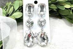 Be sure to check our shop announcements for any current sales or coupon codes!  All discount information will be posted there.  Crystal rhinestone dangle earrings: Approximate length: 3" Stone color: clear crystal Metal color: silver Back- Post back Nickel and lead compliant **Variance in computer monitors AND the lack of getting an exact match in person can make the color match tricky  I try to post several pictures at different angles to try to make this as easy as possible.   Feel free to ask Crystal Earrings With Rhinestones, White Sparkling Crystal Earrings, Sparkling White Crystal Earrings, White Bling Crystal Drop Earrings, White Crystal Chandelier Earrings With Rhinestones, White Crystal Earrings With Bling, White Bling Crystal Earrings In Cubic Zirconia, White Cubic Zirconia Crystal Earrings With Bling, White Bling Crystal Earrings With Cubic Zirconia