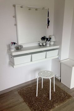 a white table and mirror in a room